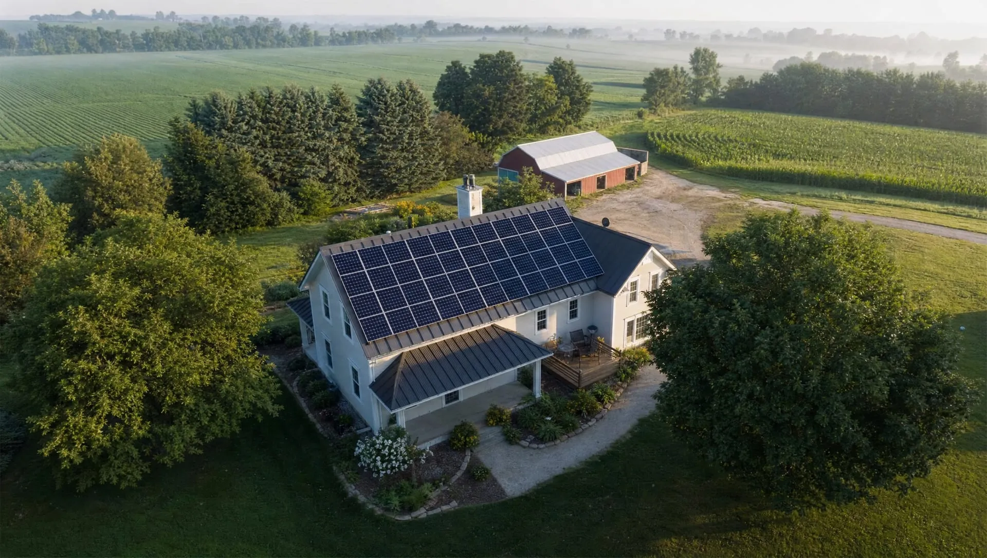 Aerial view of a rural home with a rooftop solar array